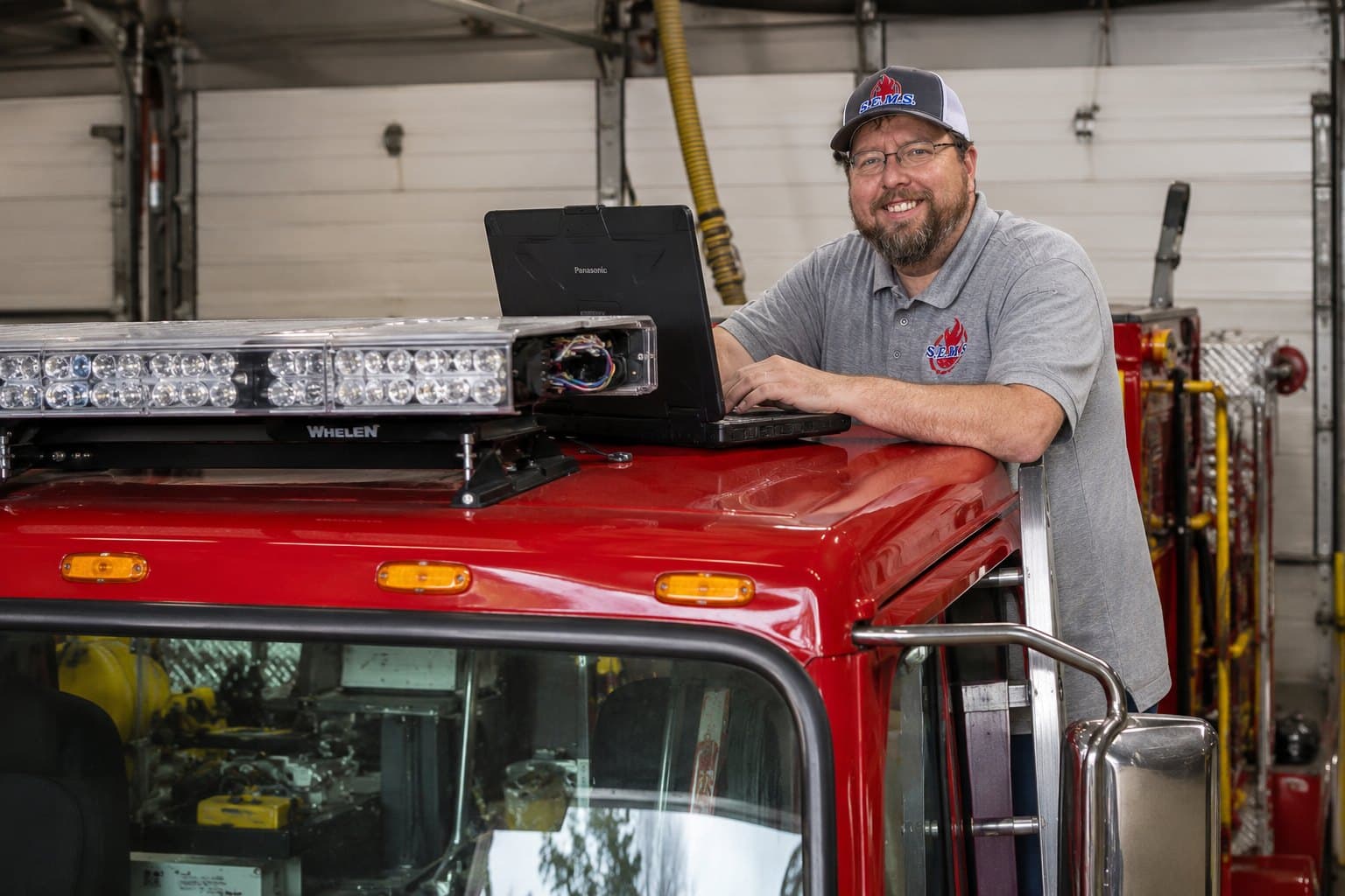 SEMS technician programming a Whelen lightbar on a fire apparatus during a lighting upgrade